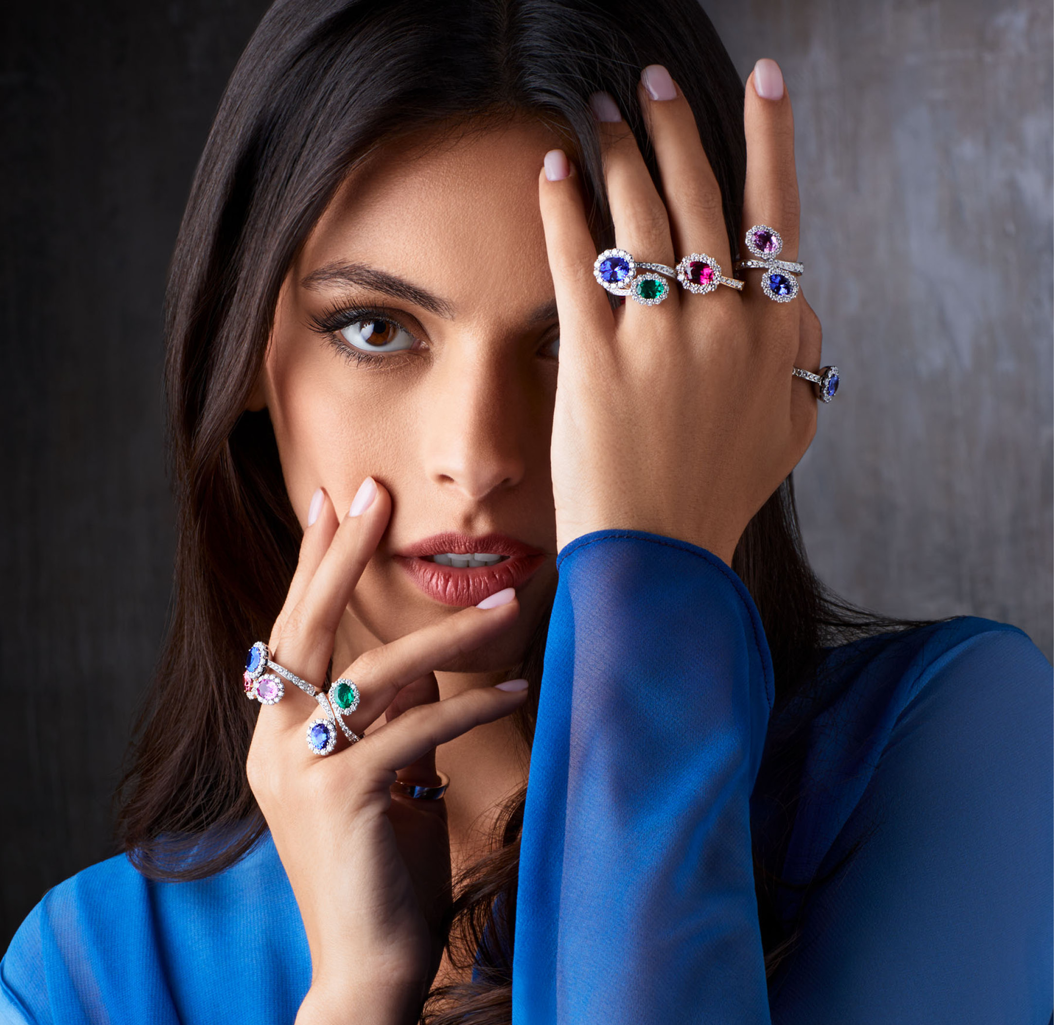 Photo of woman wearing the design rings in white gold, with diamonds and stones of color (emerald, tanzanite, sapphire, ruby) from the collection Like Me Chapter Two Giorgio Visconti